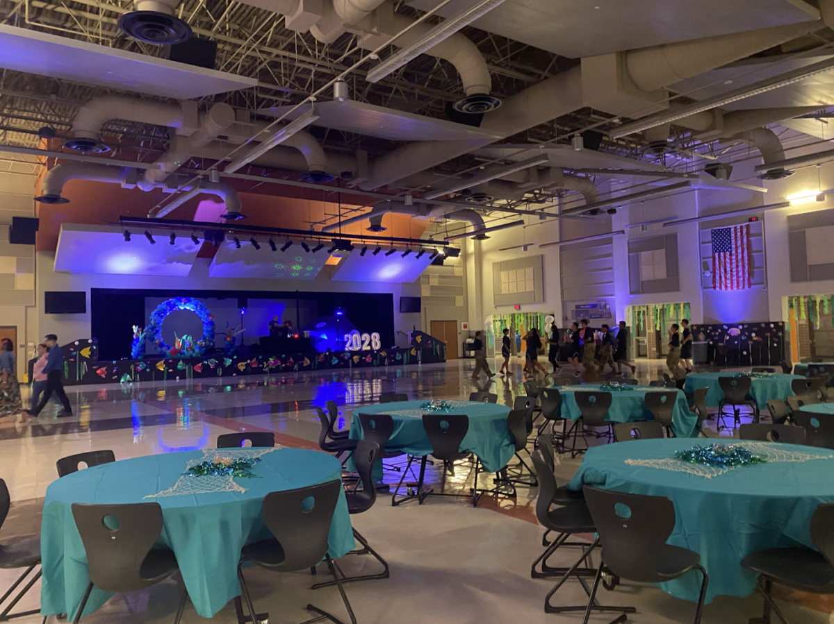 Rushing to the cafeteria in anticipation of the upcoming night of festivities, freshmen flock to catch a table. Prior to the dance, the annual Fish Bowl event consisted of a club fair and pep-rally. 